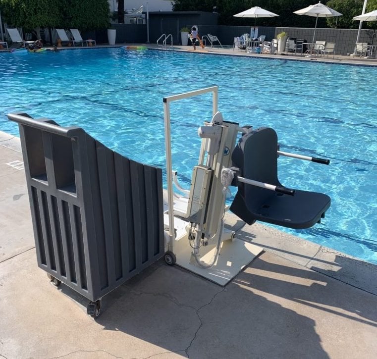 pool lift mounted next to an olympic size pool with painted lanes